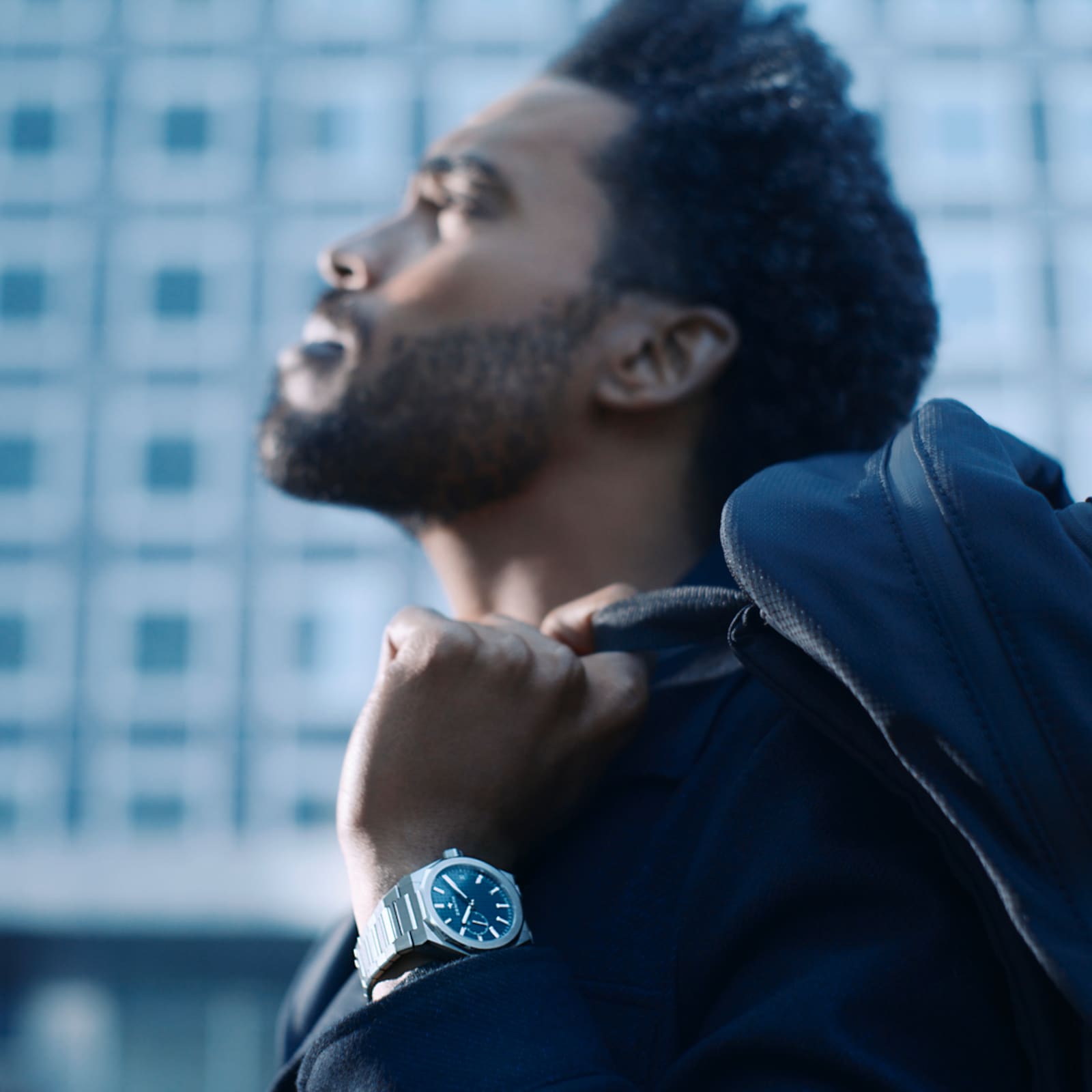 Model wearing a Zenith DEFY Skyline with a dark blue jacket.